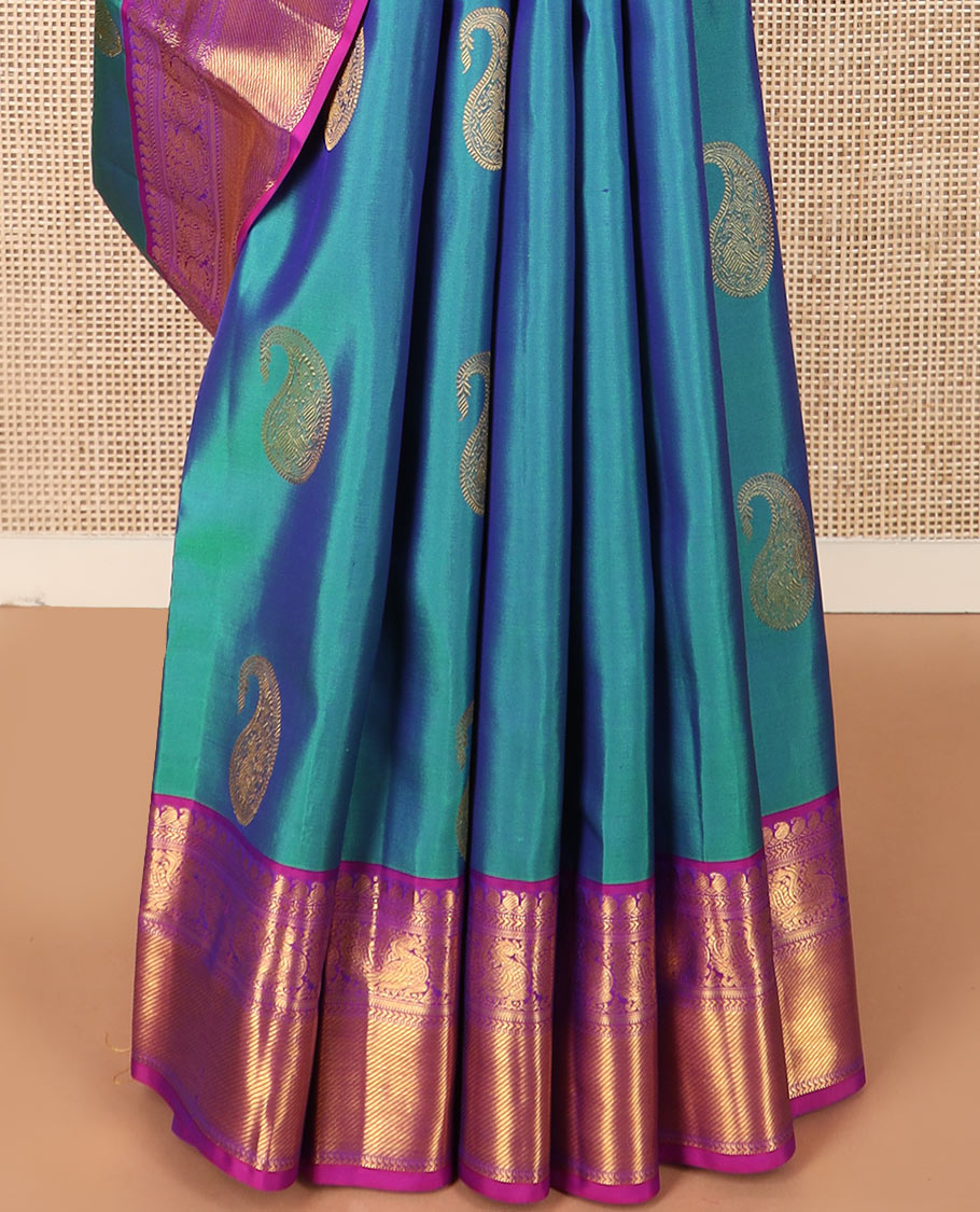 Blue arumbu manga buttas Kanchipuram silk saree, contrast border of manga mokku, muthu, kathir, and mayil designs, and vanki design pallu