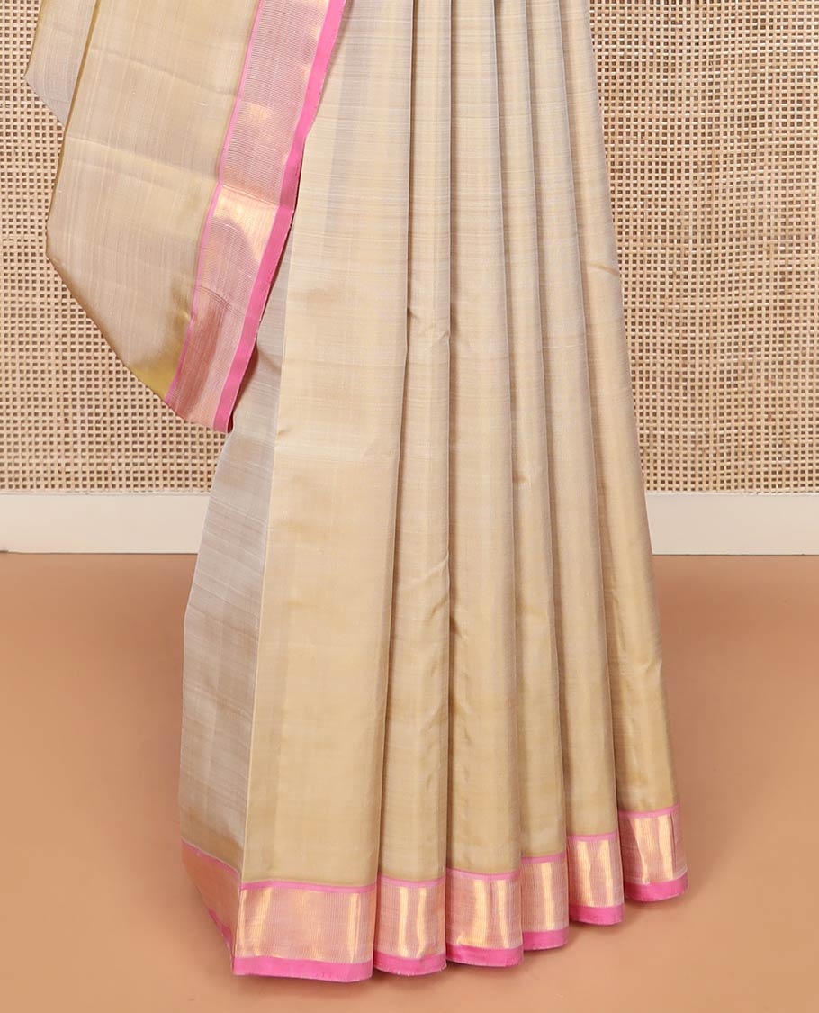 Light Sandal Plain Kanchipuram Silk Saree Subtly Sparkled with Contrast Zari Border, Pallu Features Zari Designs, and Paired with a Contrast Blouse