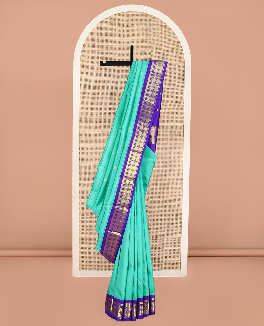 Turquoise Kanchipuram Silk Saree, Beautified with Zari Buttas on Its Body, Complemented by a Contrast One-Sided Korvai Border of Vanki, Banaras, and Rudraksham Designs, Pallu of Zari Designs, and Comes Without a Blouse