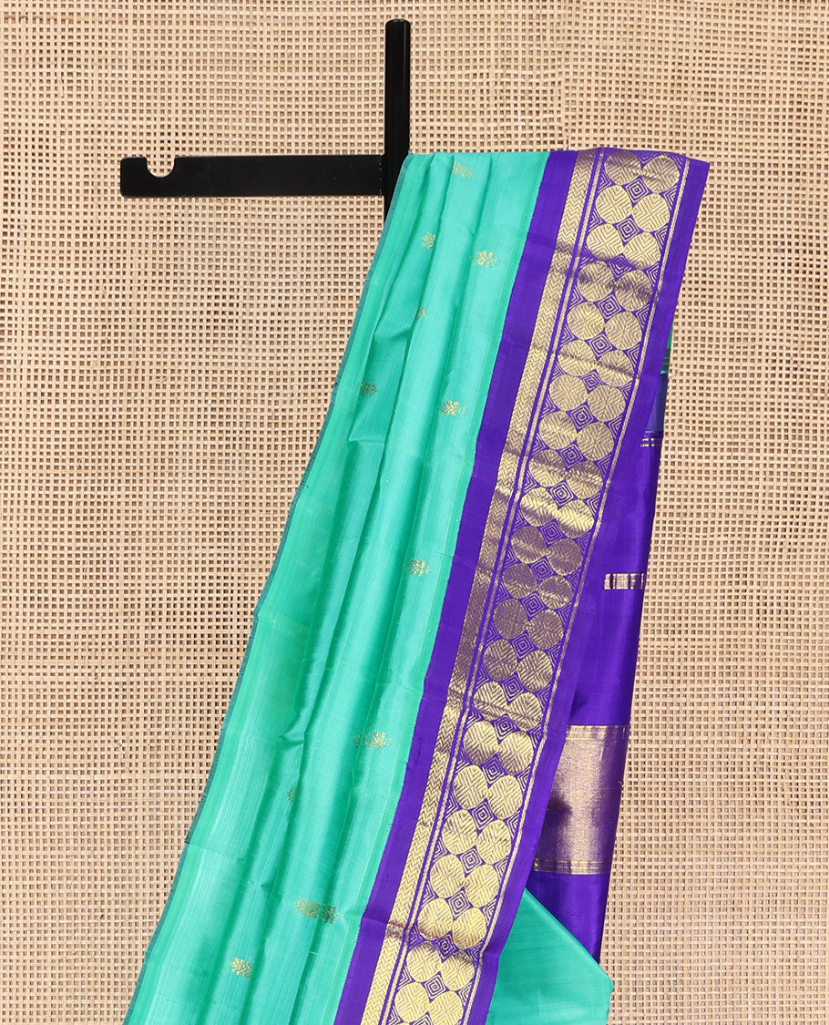 Turquoise Kanchipuram Silk Saree, Beautified with Zari Buttas on Its Body, Complemented by a Contrast One-Sided Korvai Border of Vanki, Banaras, and Rudraksham Designs, Pallu of Zari Designs, and Comes Without a Blouse