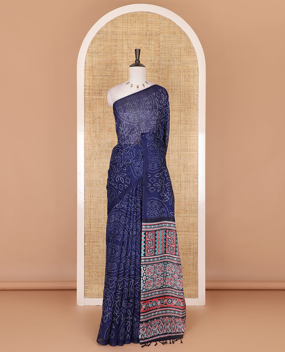 Borderless blue bandhani style floral, paisley, and chakra printed semi-jute silk saree, contrast ajrakh printed pallu, and ajrakh printed blouse