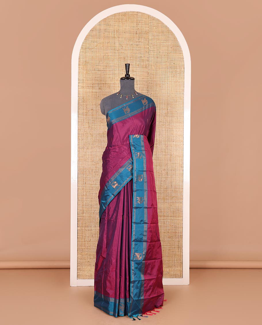 Magenta zari buttas Kanchi silk saree, contrast yaali motifs zari blue border, zari design pallu, and a matching blouse