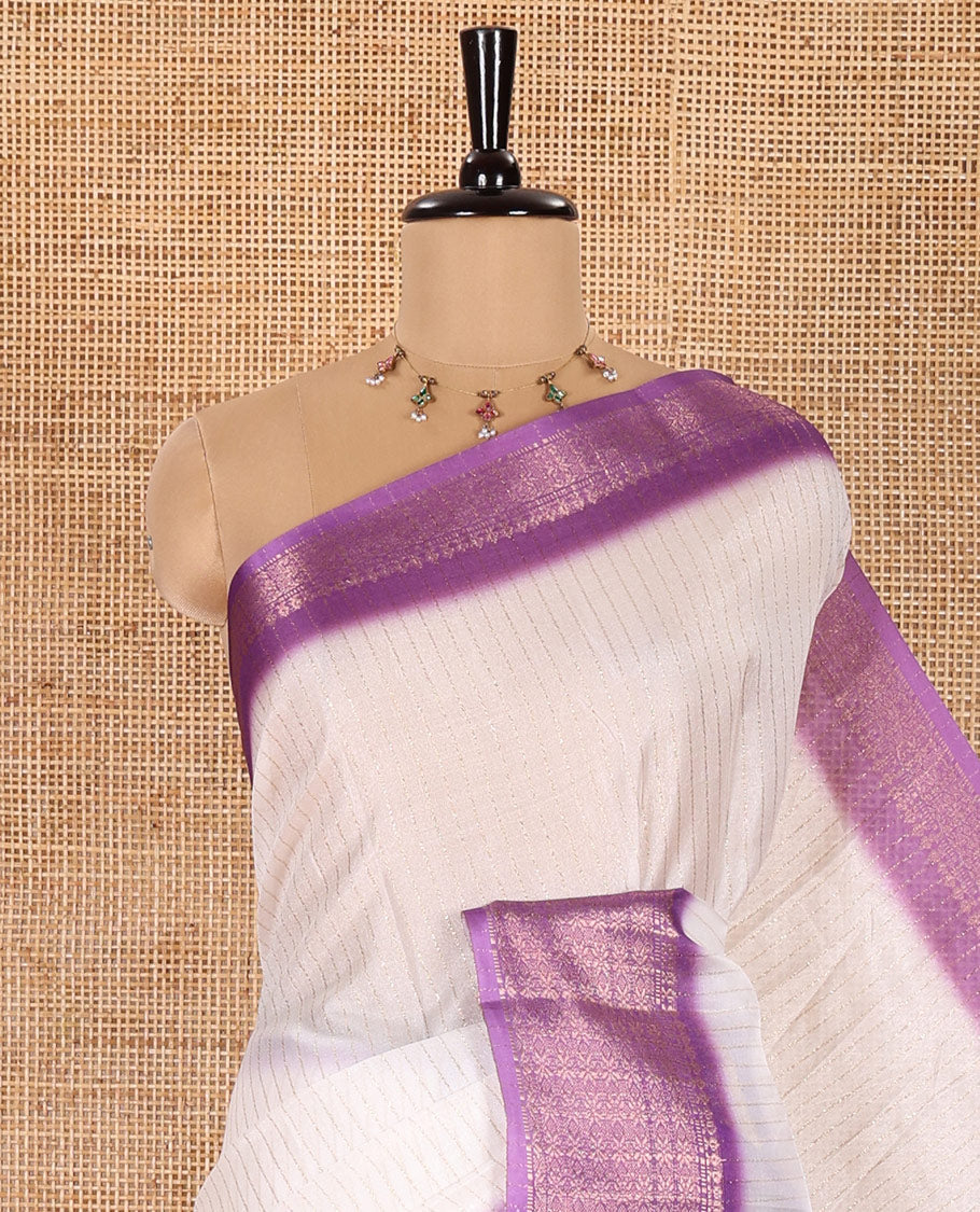 White and Lavender Dola Silk Saree Adorned with Vertical Zari Stripes All Over the Body, Complemented by a Contrast Border of Traditional Zari Designs, Self-Pallu of Stripes, and Paired with a Contrast Blouse