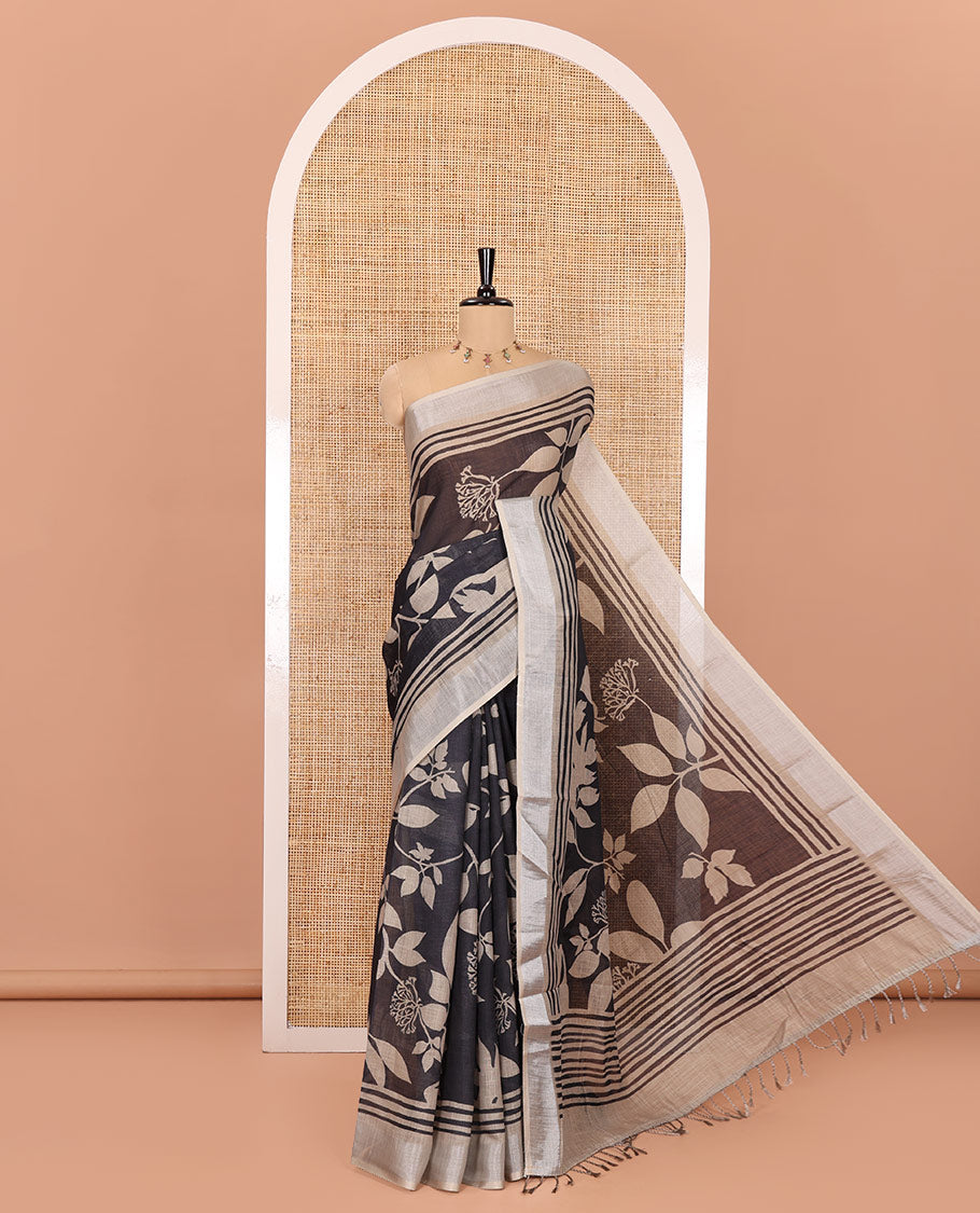 Black Linen Cotton Saree, Beautified with Floral Leaf Motifs Printed on Its Body, Subtle Bavanji Border, Pallu Features Floral Print and Stripes, and Paired with a Matching Blouse