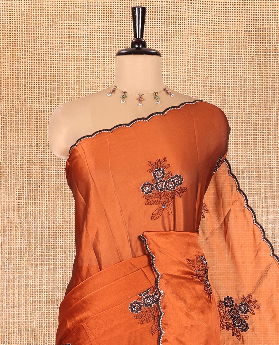 Rust Rangoli Chiffon Saree, Adorned with Flower-Style Motifs Embroidered on Its Body, a Subtle Scallop Embroidered Border, a Self-Pallu, and Paired with a Contrast Embroidered Blouse