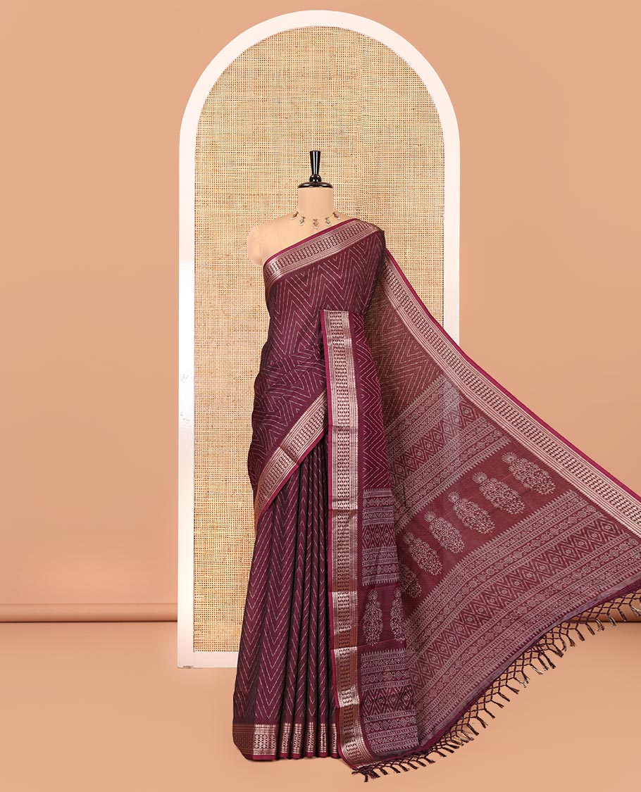 Wine Dola Silk Saree, Subtly Sparkled with Chevron Stripes on Its Body, Highlighted by Traditional Zari Design Border, Intricately Designed Pallu, and Paired with a Matching Blouse