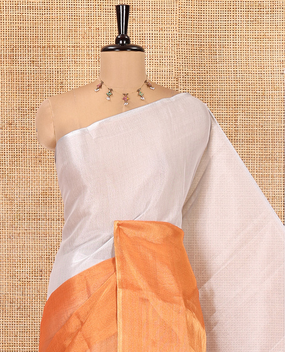 Borderless Orange Plain Tissue Saree, a Self-Pallu with Tassels, and a Matching Blouse