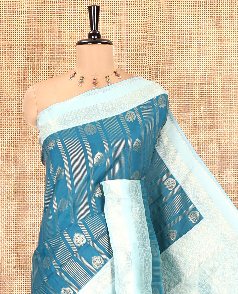 Peacock Blue Litchi Saree, Elevated with Vaira Oosi Stripes and Zari Buttas on Its Body, Complemented by a Contrast Rettai Pettu Traditional Zari Design Border, an Intricately Designed Pallu, and Paired with a Contrast Blouse