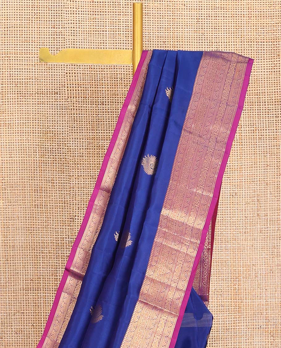 Blue Vasundhara Lite-Silk Mix Saree, Adorned with Zari Buttas, Complemented by Contrast Border Featuring Thilakam Mokku, Kodi Visiry, Muthu, Laddu Kamalam, and Mayil Designs, Grandly Pallu of Scallop Designs, and Paired with a Contrast Blouse
