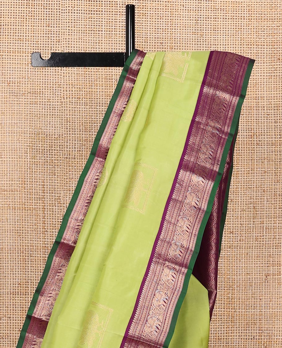 Green silk saree with box mayil and chakram buttas, contrast border of thilakam mokku,muthu,kathir & yaanai designs & jaal pallu