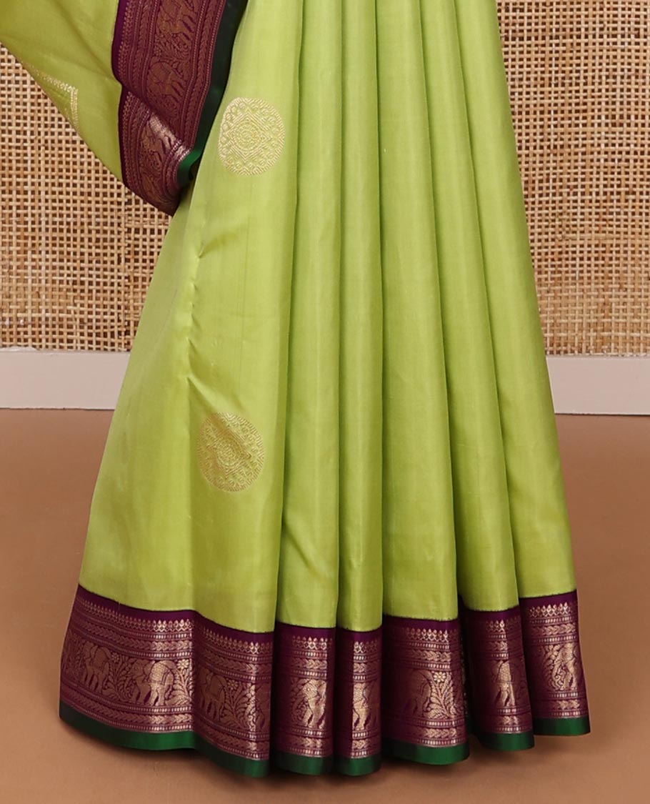 Green silk saree with box mayil and chakram buttas, contrast border of thilakam mokku,muthu,kathir & yaanai designs & jaal pallu