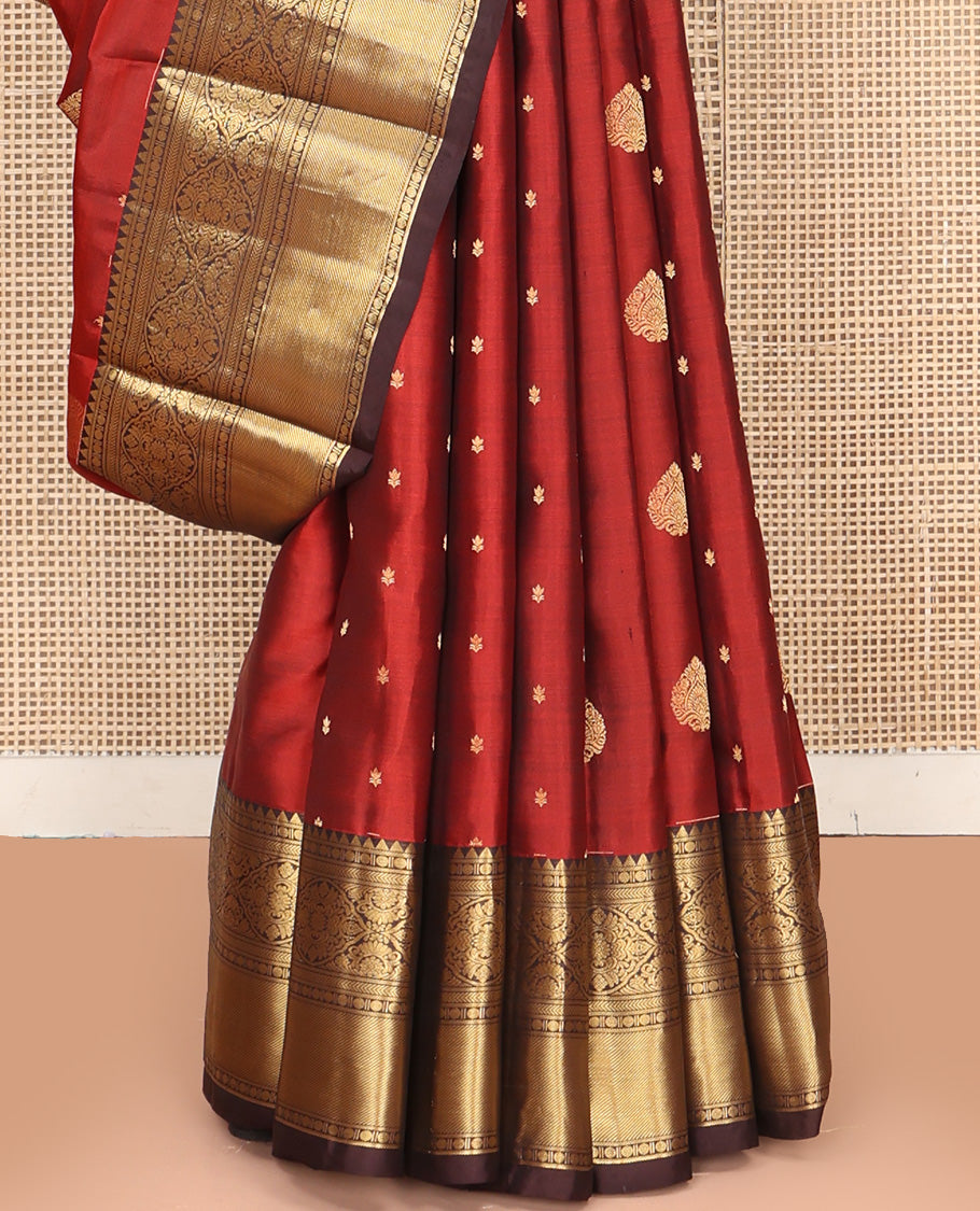 Maroon Vasundhara Silk Saree, Decked Up with Zari Buttas All Over Its Body, Complemented by Contrast Border of Rekku Poun, Muthu, and Floral Designs, Grand Jaal Pallu and Paired with a Contrast Blouse
