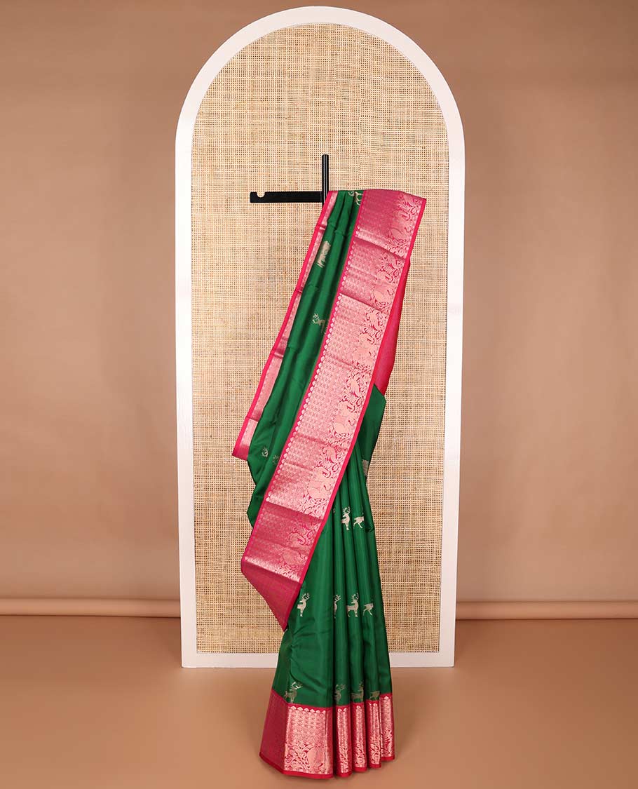 Dark green deer design silk saree with contrast border of leaf, paun, yanaai design & floral design pallu