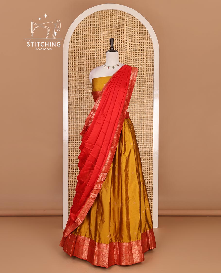 Mustard taffeta silk half saree, zari buttas with contrast red traditional zari border, matching zari blouse, and contrast plain zari border dhavani