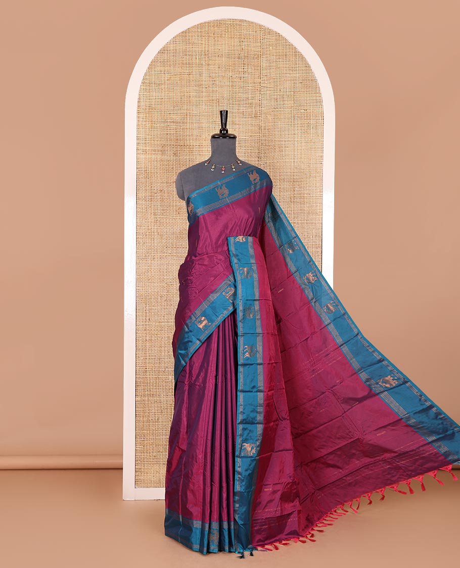 Magenta zari buttas Kanchi silk saree, contrast yaali motifs zari blue border, zari design pallu, and a matching blouse