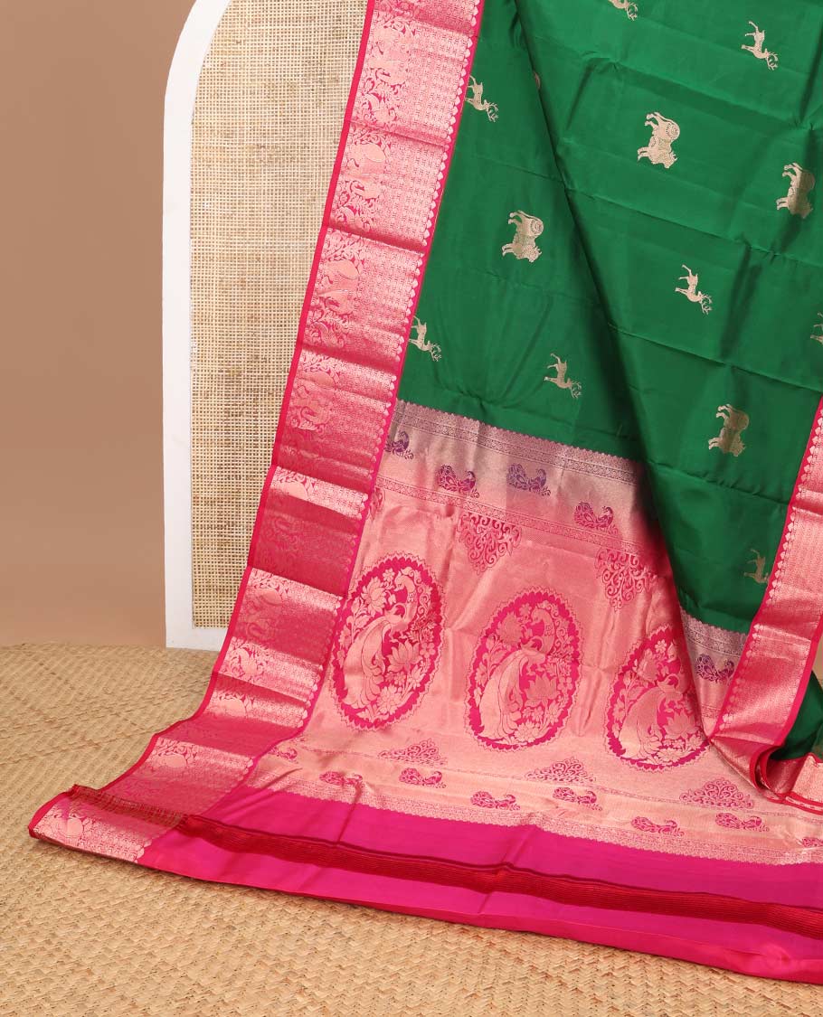 Dark green deer design silk saree with contrast border of leaf, paun, yanaai design & floral design pallu