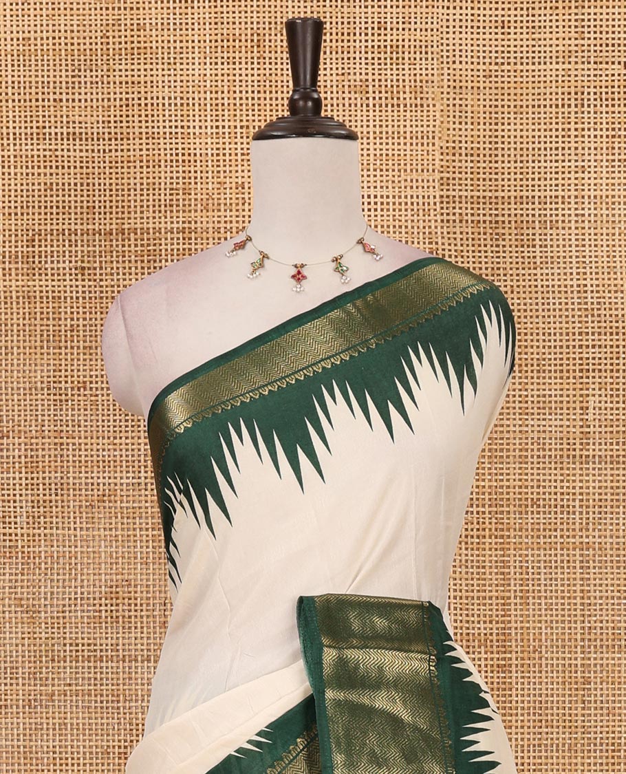 Cream-green plain dola-tussar saree, contrast temple zari border, patola animal motifs enclosed jaal printed pallu & patola printed blouse