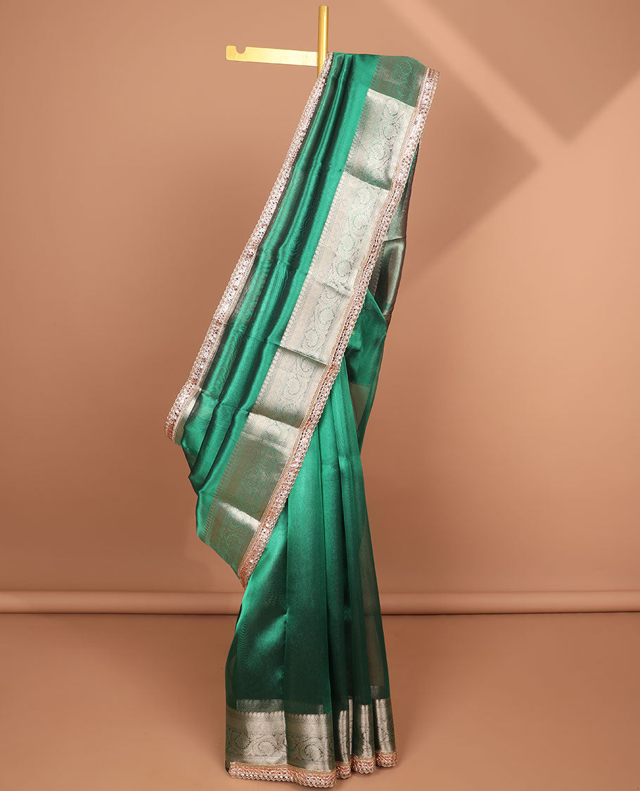 Dark green tissue saree with self zari design border & intricate zari design pallu