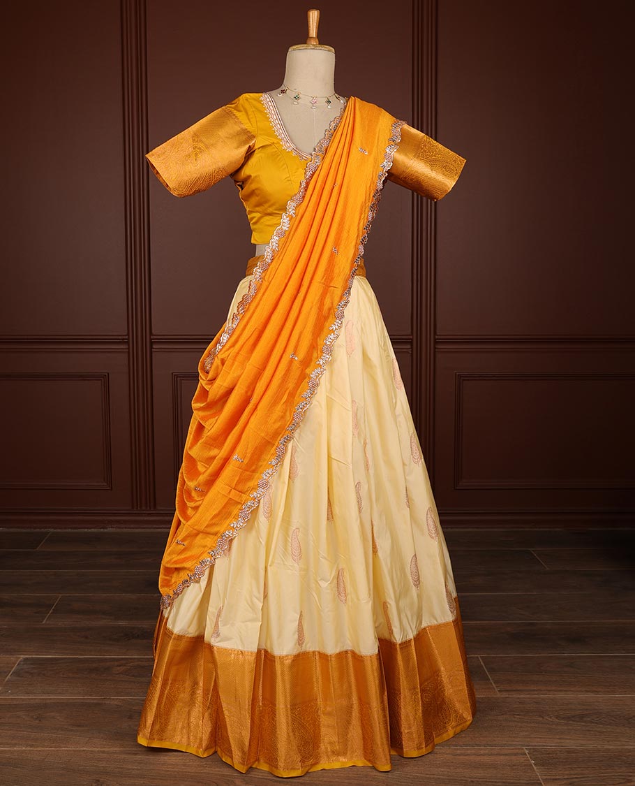 Cream paisley half saree witn contrast zari design border, floral embroidery blouse & floral embroidery dhavani