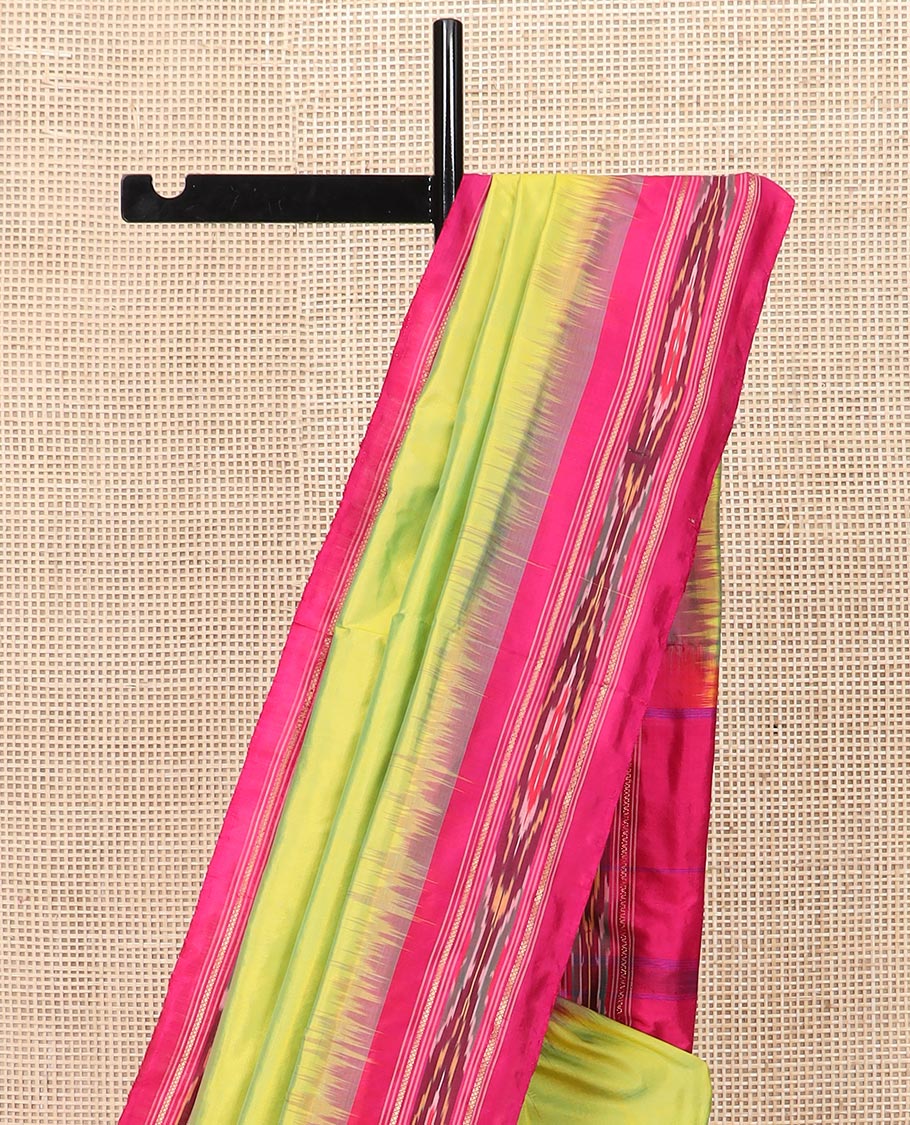 Green Plain Ikkat Silk Saree with a Contrast Rani Pink Border Accentuated by a Hazy Ikkat Weave, Featuring a Pallu Flanked by Stripes and Ikkat Texture