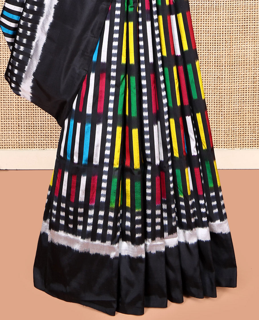 Black Pochampally Ikat Saree Features Kaleidoscopic-Colored Ikat Buttas, a Plain Border, Ikat-Style Buttas Pallu, and a Matching Blouse