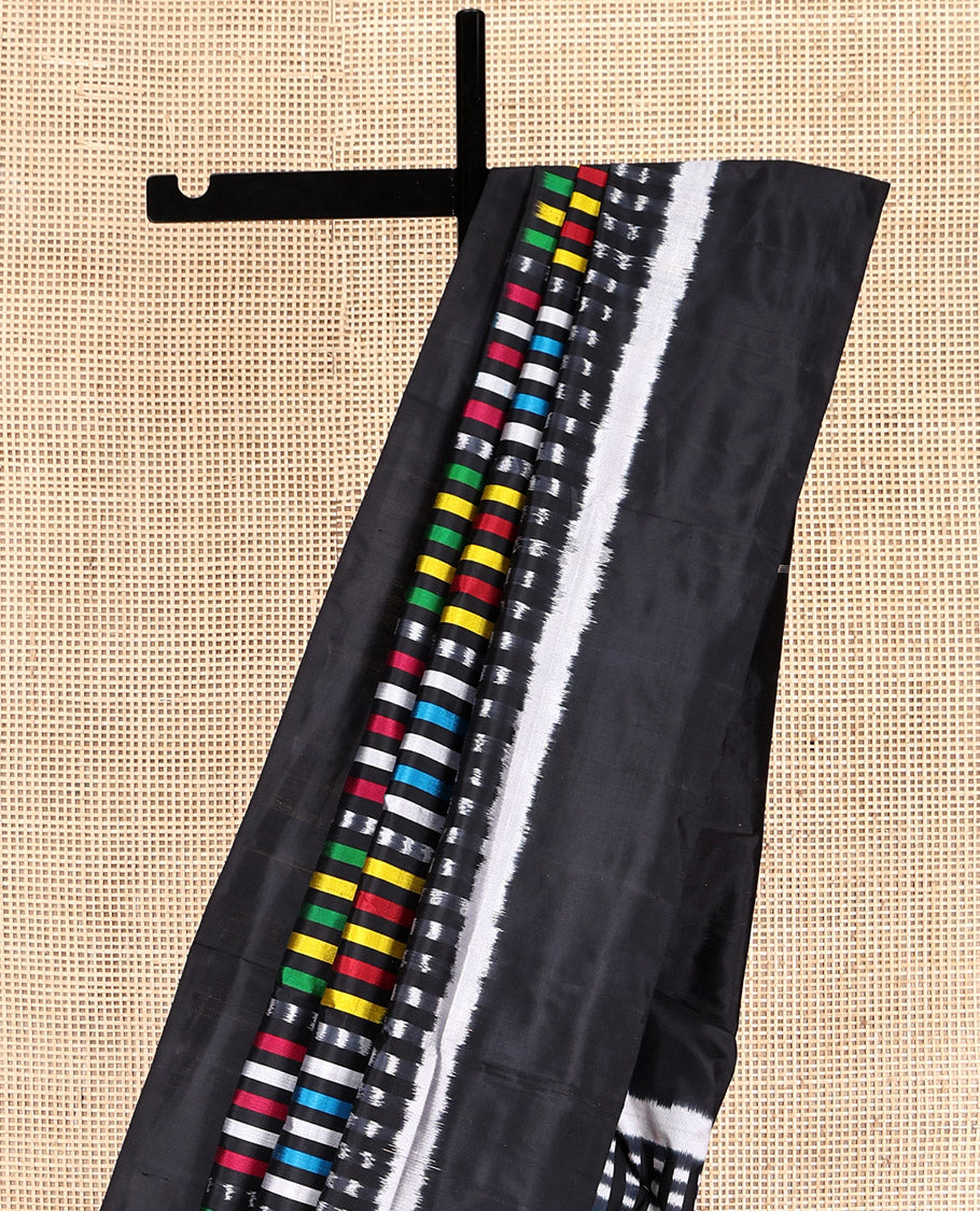 Black Pochampally Ikat Saree Features Kaleidoscopic-Colored Ikat Buttas, a Plain Border, Ikat-Style Buttas Pallu, and a Matching Blouse
