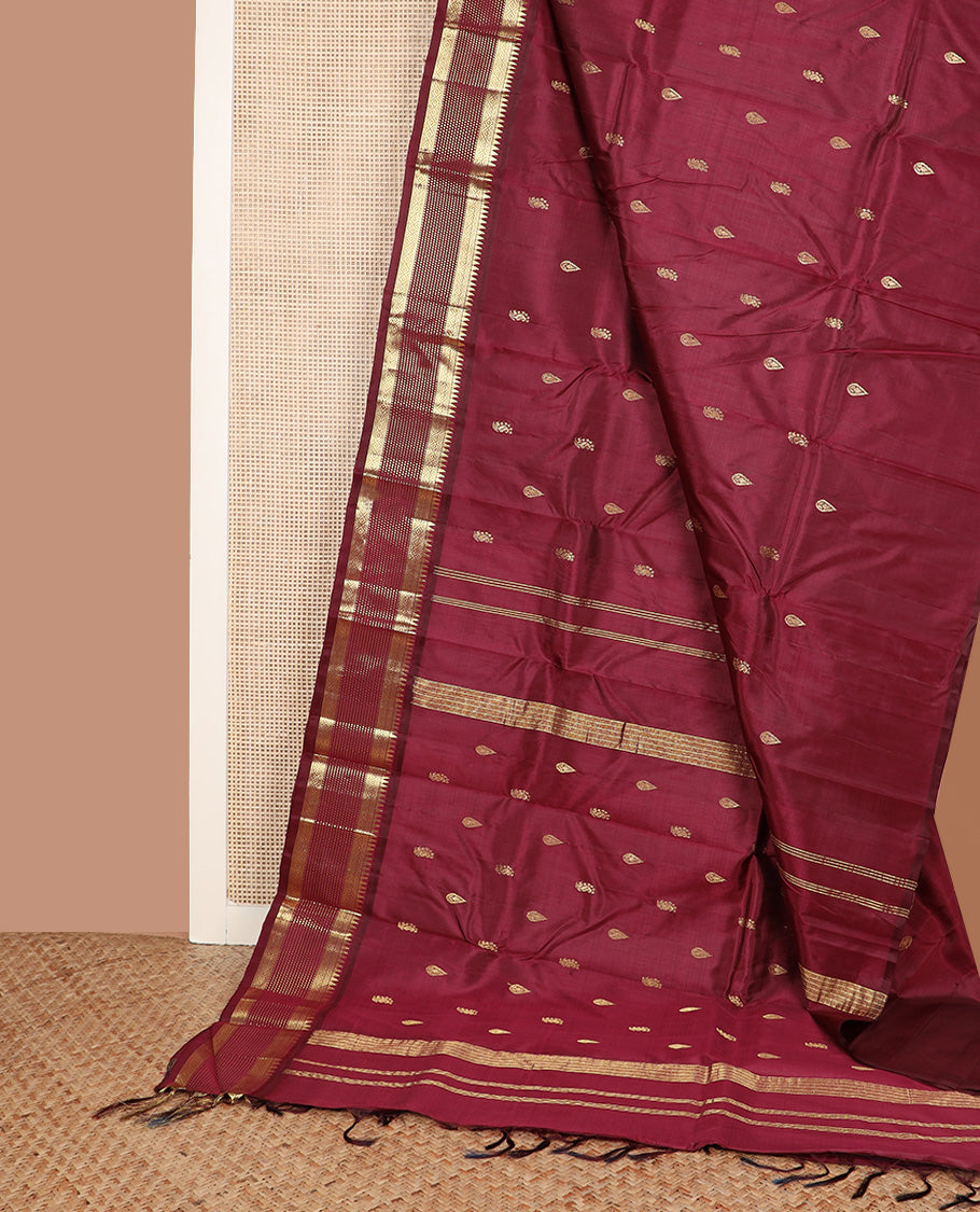 Maroon zari buttas Kanchipuram silk saree, one-sided zari border of thazampoo rekku, banaras, diamond, and muthu stripes, and zari design pallu