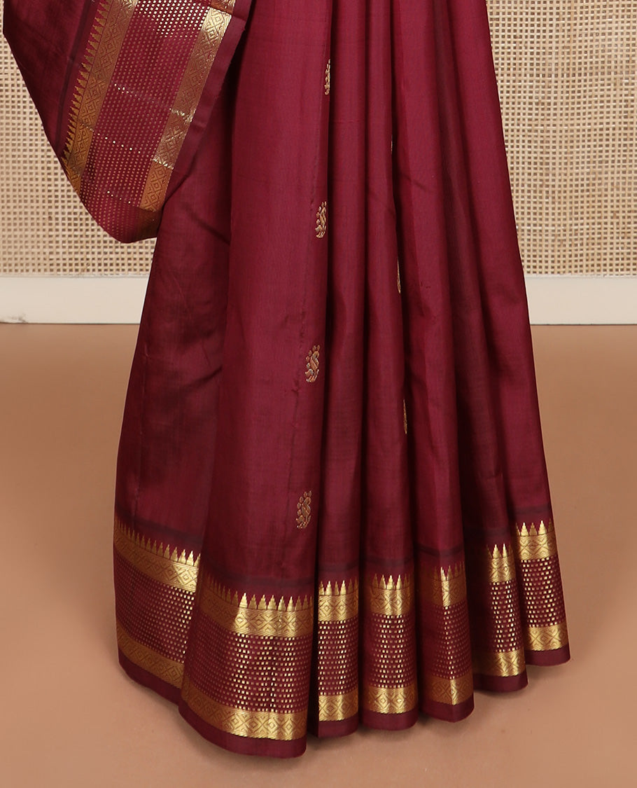 Maroon zari buttas Kanchipuram silk saree, one-sided zari border of thazampoo rekku, banaras, diamond, and muthu stripes, and zari design pallu