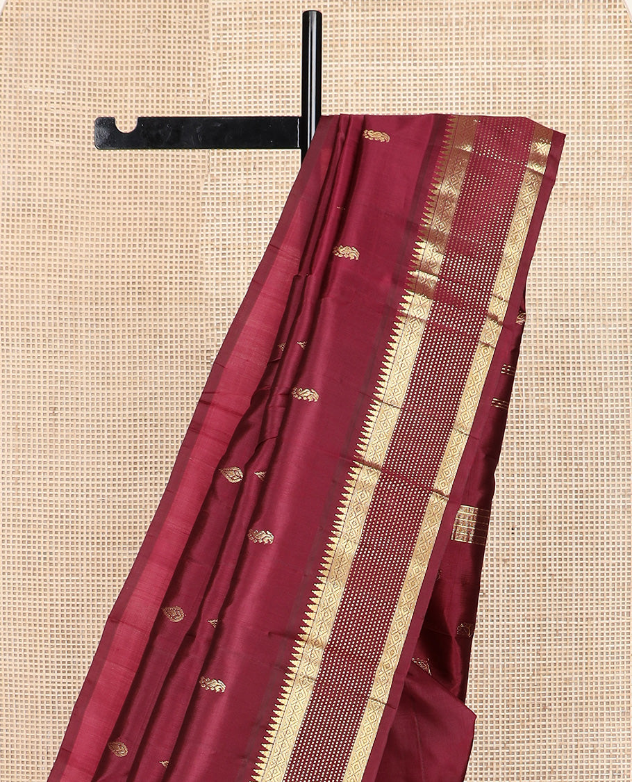 Maroon zari buttas Kanchipuram silk saree, one-sided zari border of thazampoo rekku, banaras, diamond, and muthu stripes, and zari design pallu
