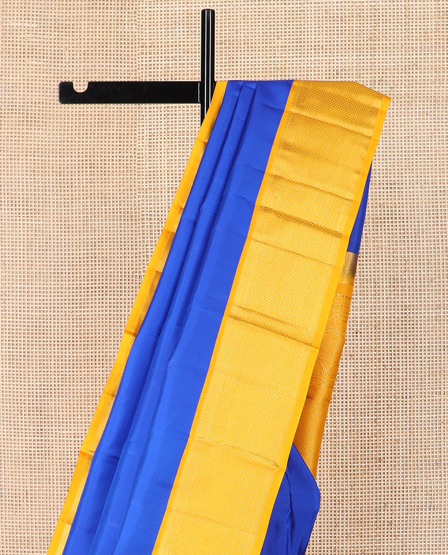 Royal blue plain Kanchipuram silk saree, contrast border of salngai, muthu, and ara maadam designs, and intricate pallu