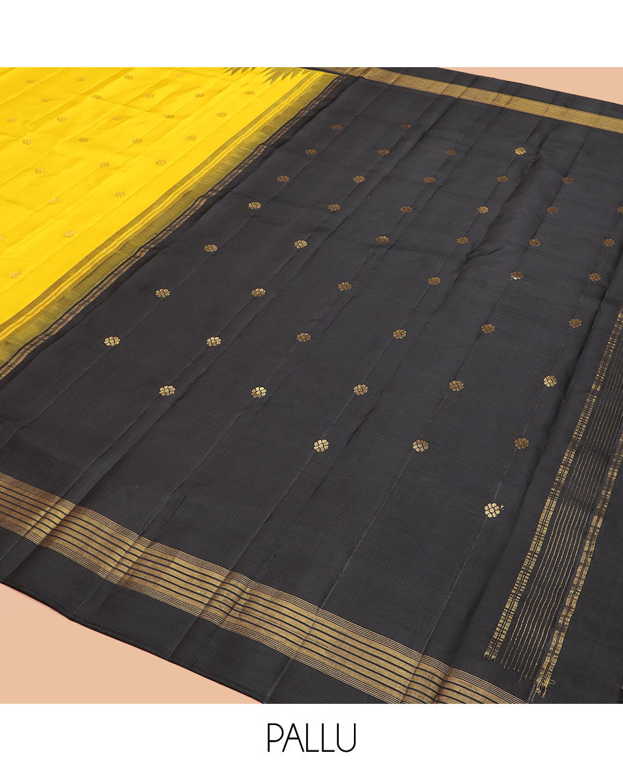 Yellow zari buttas Kanchipuram silk saree, contrast thazampoo rekku zari border, and pallu features kamalam designs