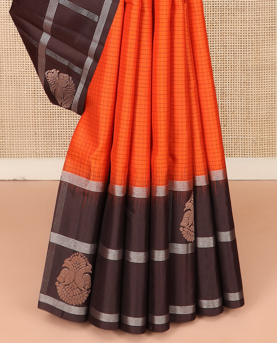 Orange Kanchipuram Silk Saree Sparsely Sparkled Checks on Its Body, Complemented by a Contrast Border of Iruthalai Pakshi Butta Enclosed Checks, Gleaming Pallu of Jaal Designs, and Paired with a Contrast Blouse