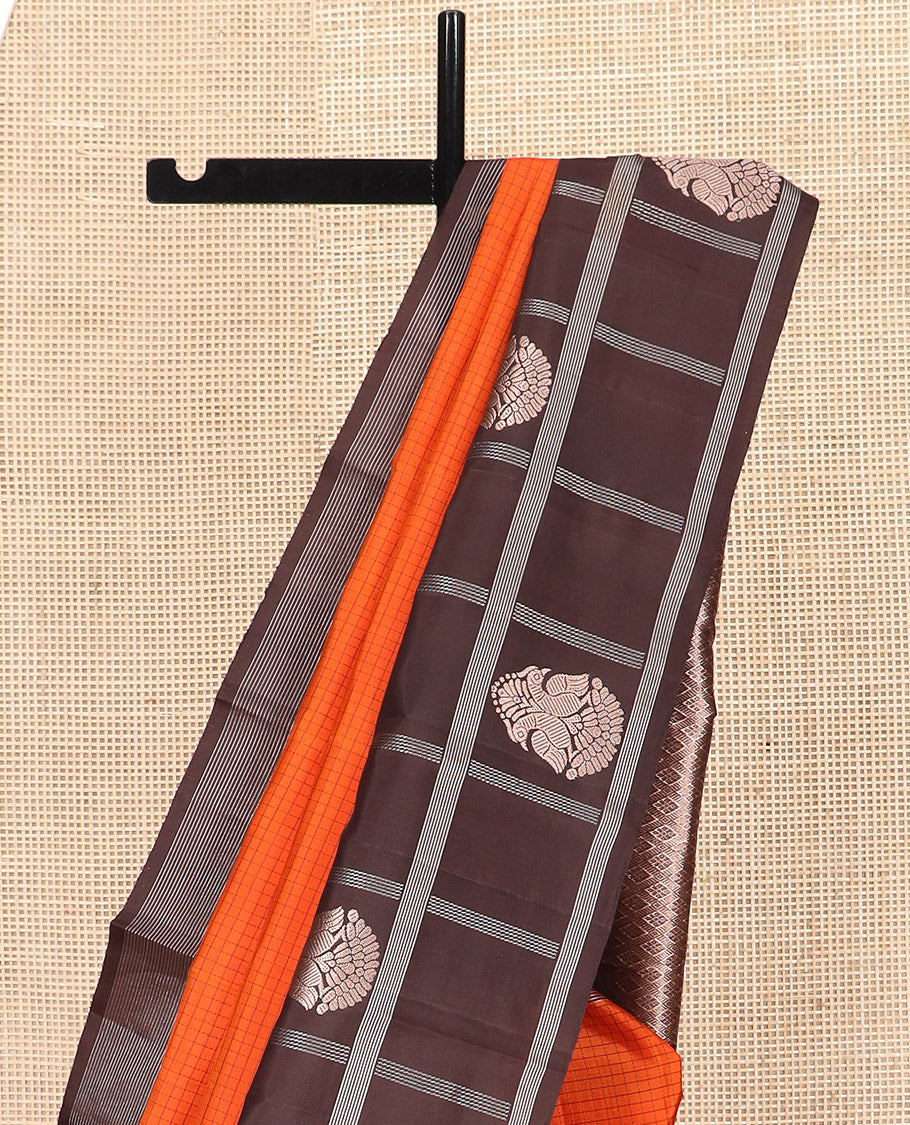 Orange Kanchipuram Silk Saree Sparsely Sparkled Checks on Its Body, Complemented by a Contrast Border of Iruthalai Pakshi Butta Enclosed Checks, Gleaming Pallu of Jaal Designs, and Paired with a Contrast Blouse