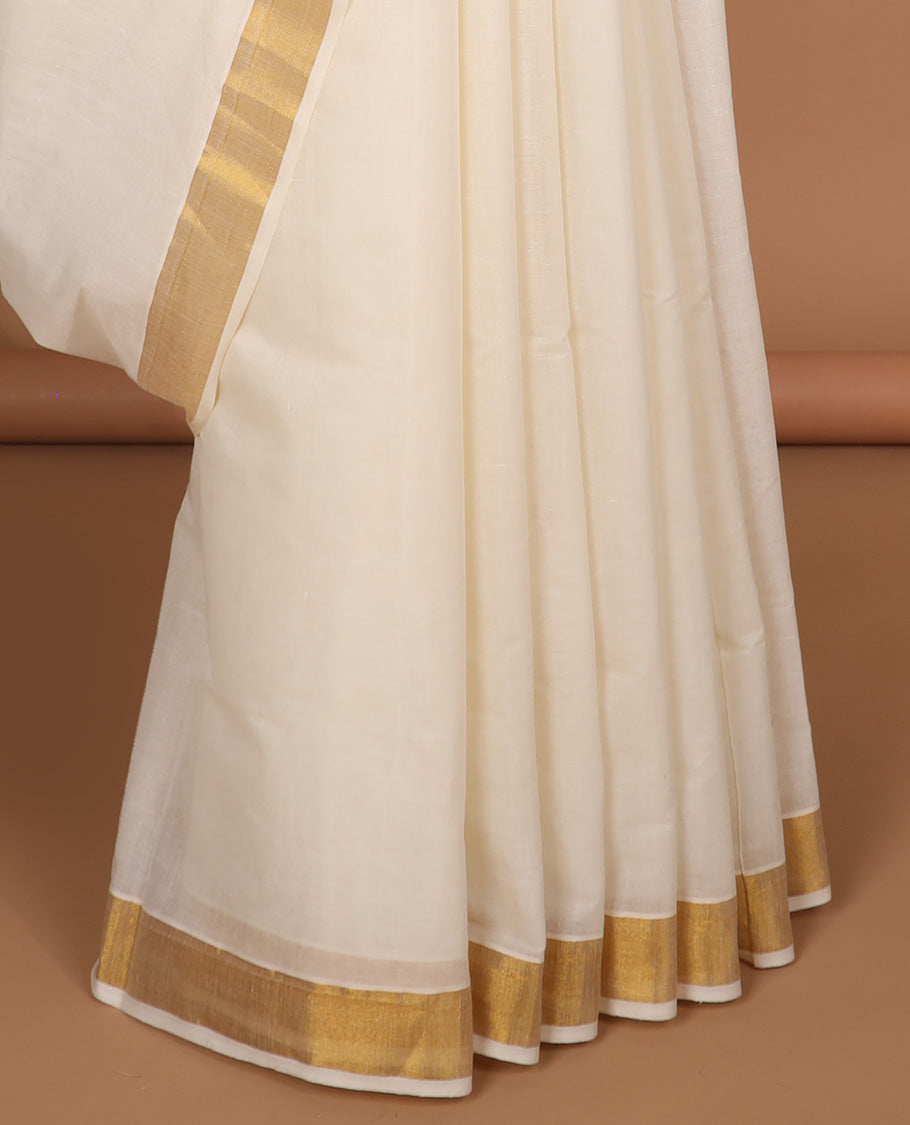 Cream kerala saree with zari designs, zari border & pallu of intricate zari designs