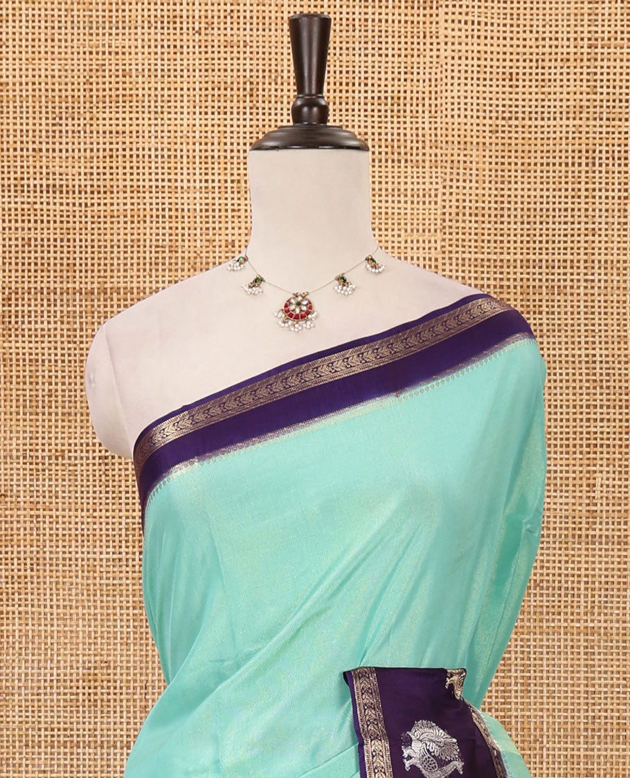 Blue plain Banarasi tissue silk saree, contrast traditional zari peacock border, zari striped pallu & floral jaal jacquard purple blouse