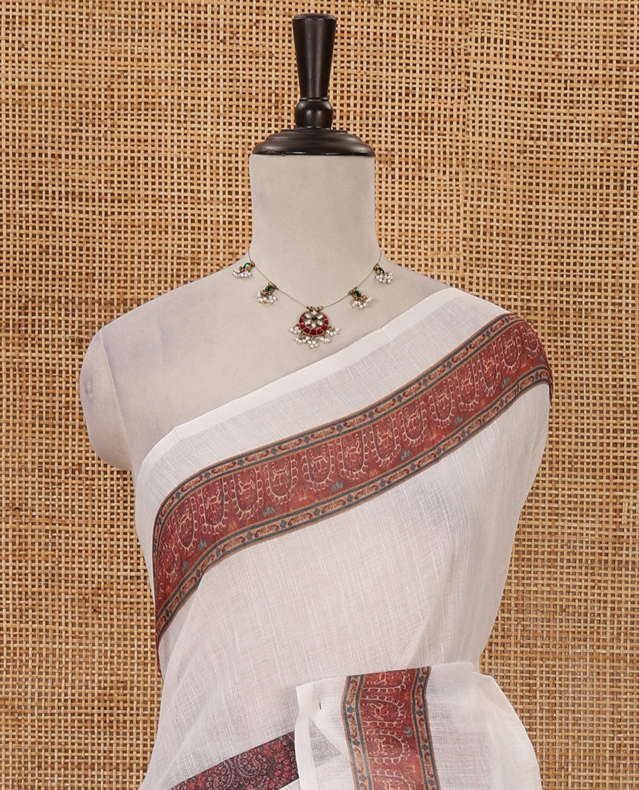 White half-plain & half-printed linen cotton saree, brown-color printed border, paisley motifs printed pallu & uniquely printed blouse