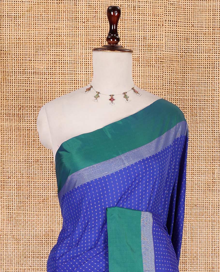 Royal blue-green plus-shaped buttas steeped semi-soft silk saree, contrast satin border of stripes, striped pallu, and contrast blouse