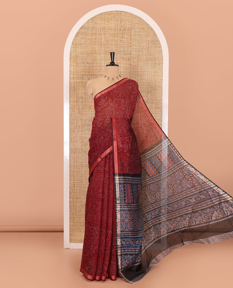 Maroon bandhani-style floral and chakra printed saree, zari piping border, contrast ajrakh printed pallu, and contrast ajrakh printed blouse