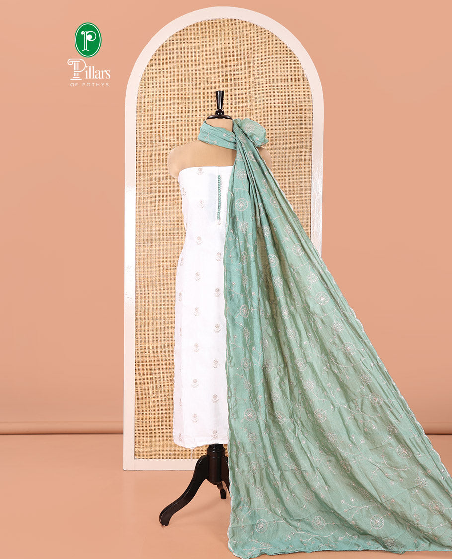 Cream with Green Vichitra Silk Material Chudidar Set, Elevated with Gold Zari Buttas On Its Top, a Plain Santoon Bottom, and Comes with a Floral Vine Sequins Embroidered Dupatta