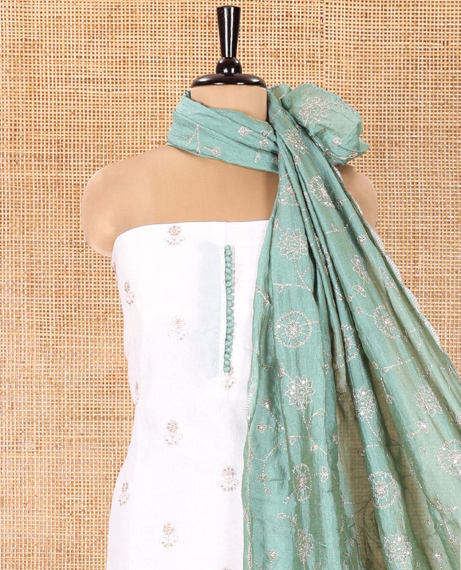 Cream with Green Vichitra Silk Material Chudidar Set, Elevated with Gold Zari Buttas On Its Top, a Plain Santoon Bottom, and Comes with a Floral Vine Sequins Embroidered Dupatta
