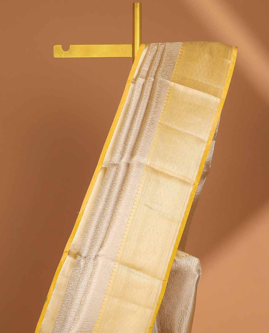 Beige motifs semi tissue saree with contrast zari design border & intricate zari design pallu