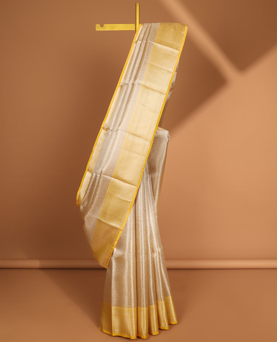 Beige motifs semi tissue saree with contrast zari design border & intricate zari design pallu
