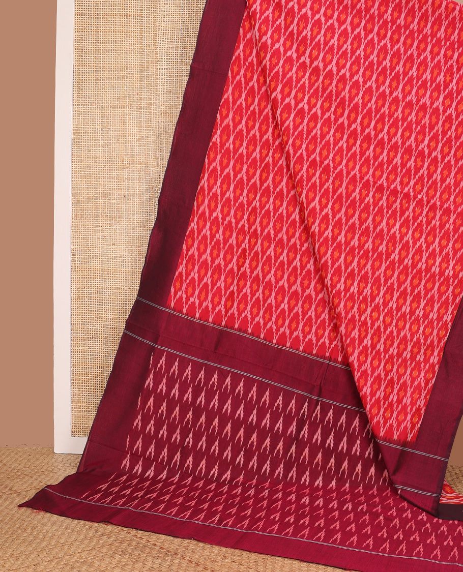 Red ogee patterned ikkat cotton saree, contrast plain border, and pallu of triangle buttas