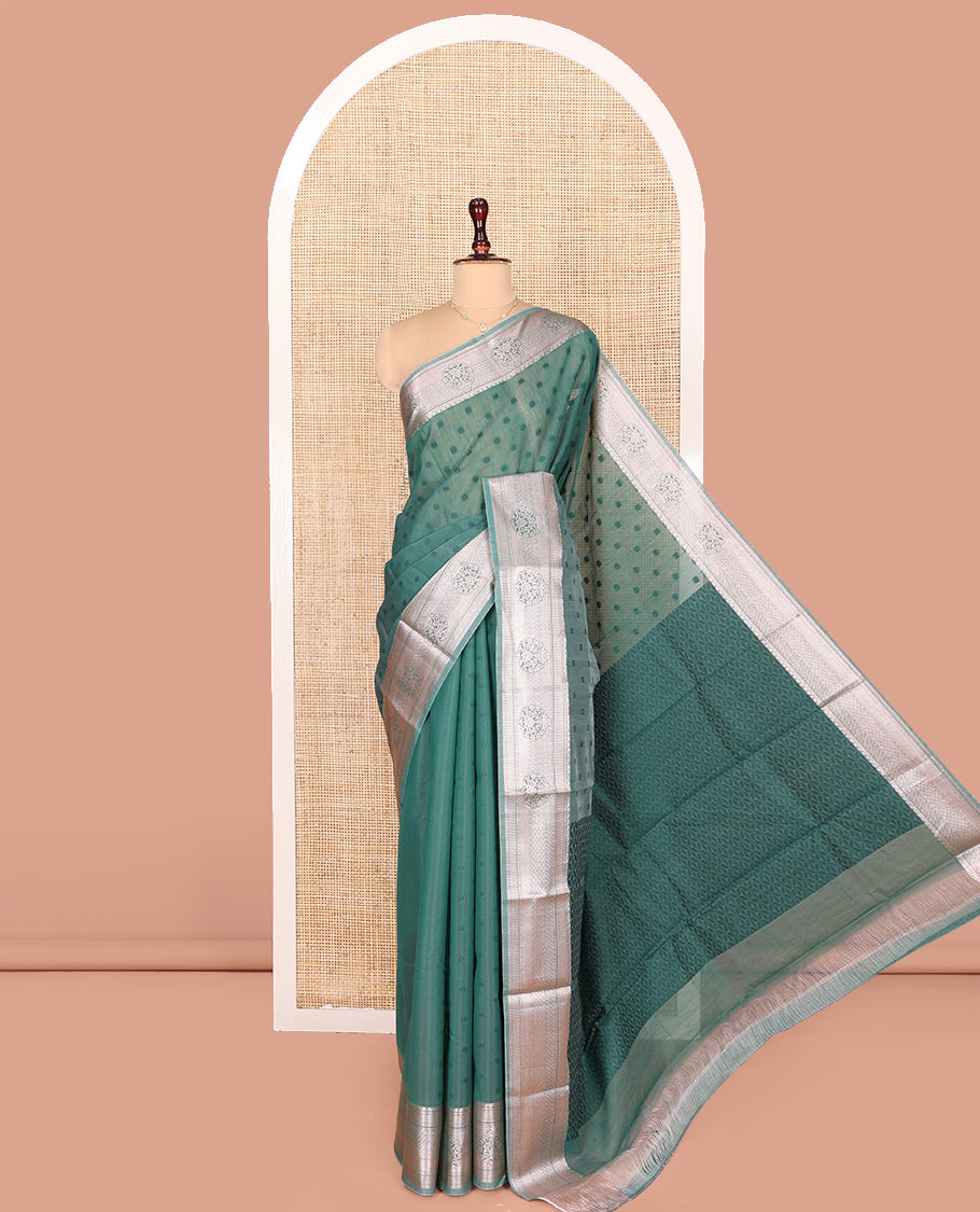 Blue Semi-Silk Cotton Saree, Sparsely Woven with Floral Buttas on Its Body, Highlighted by a Zari Traditional Border, Geometric Patterned Pallu, and Paired with a Matching Blouse
