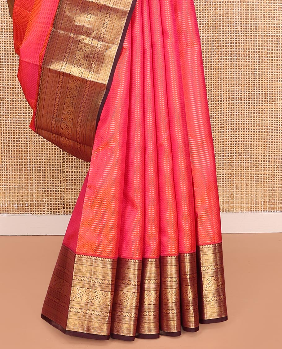 Pink Vasundhara Silk Saree, Beautifully Bedecked with Zari Stripes on Its Body, Complemented by a Contrast Border of Thilakam Mokku, Kathir, Vanki, Mayil, and Laddu Kamalam Designs, Majestically Detailed Jaal Pallu, and Paired with a Contrast Blouse