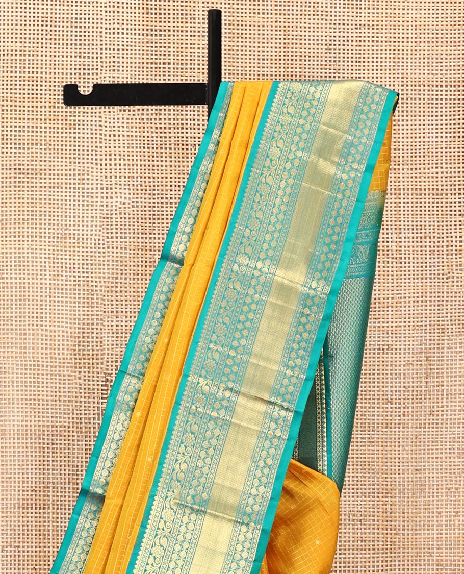 Yellow Vasundhara Silk Saree, Subtly Sparkled with Zari Buttas and Checks All Over Its Body, Complemented by a Contrast Border of Thilakam, Diamond, Kodi Visiry, and Poun Designs, Grand Pallu, and Paired with a Contrast Blouse