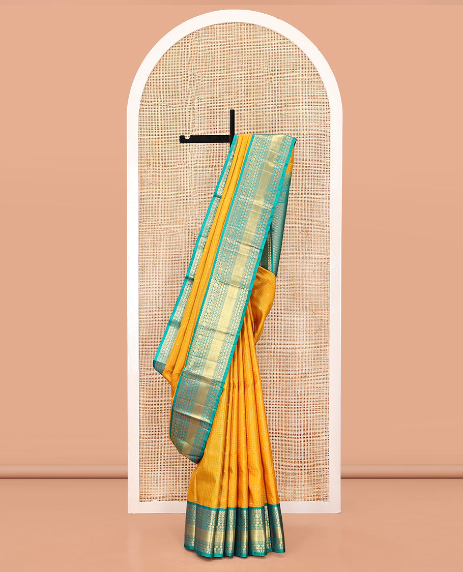 Yellow Vasundhara Silk Saree, Subtly Sparkled with Zari Buttas and Checks All Over Its Body, Complemented by a Contrast Border of Thilakam, Diamond, Kodi Visiry, and Poun Designs, Grand Pallu, and Paired with a Contrast Blouse