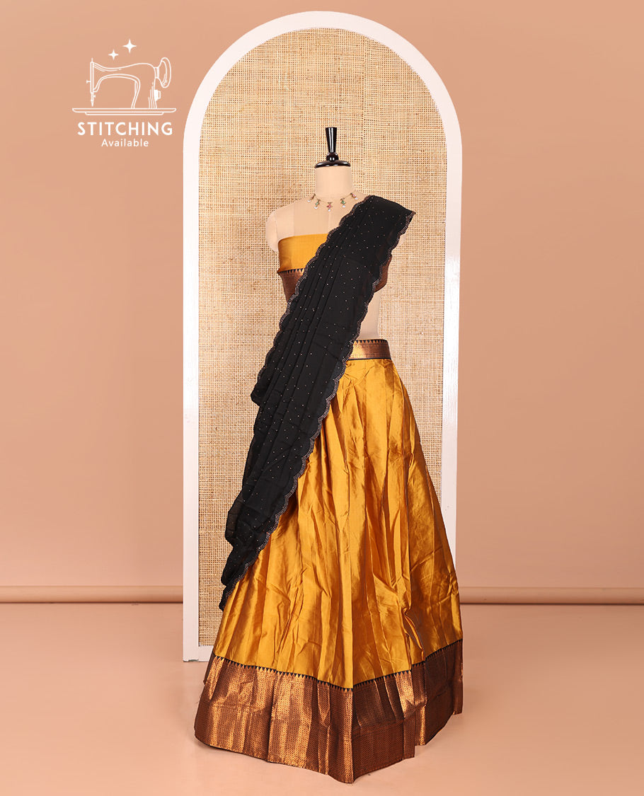 Mustrad Taffeta Silk Half-Saree Featuring a Plain Skirt, Adorned with a Contrast Traditional Zari Design Border, Paired with a Matching Blouse, and a Georgette Scallop-Bordered Stone Work Dhavani