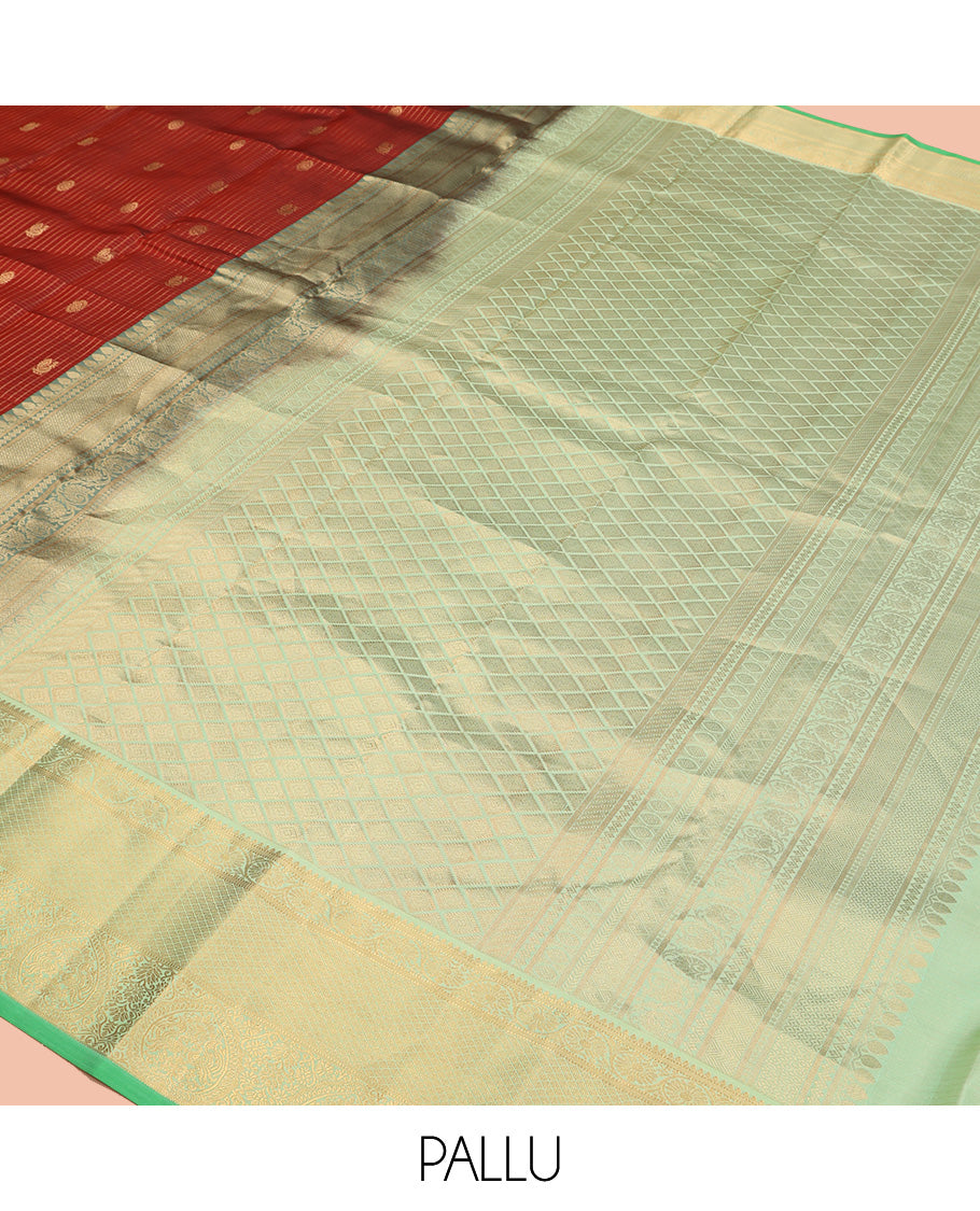 Brown Vasundhara Silk Saree, Detailed with Mayil and Chakram Buttas Enclosed Checks, Complemented by Contrast Border of Rekku, Mayil Kann, and Mayil Manga Designs, Grand Jaal Pallu and Paired with a Contrast Blouse