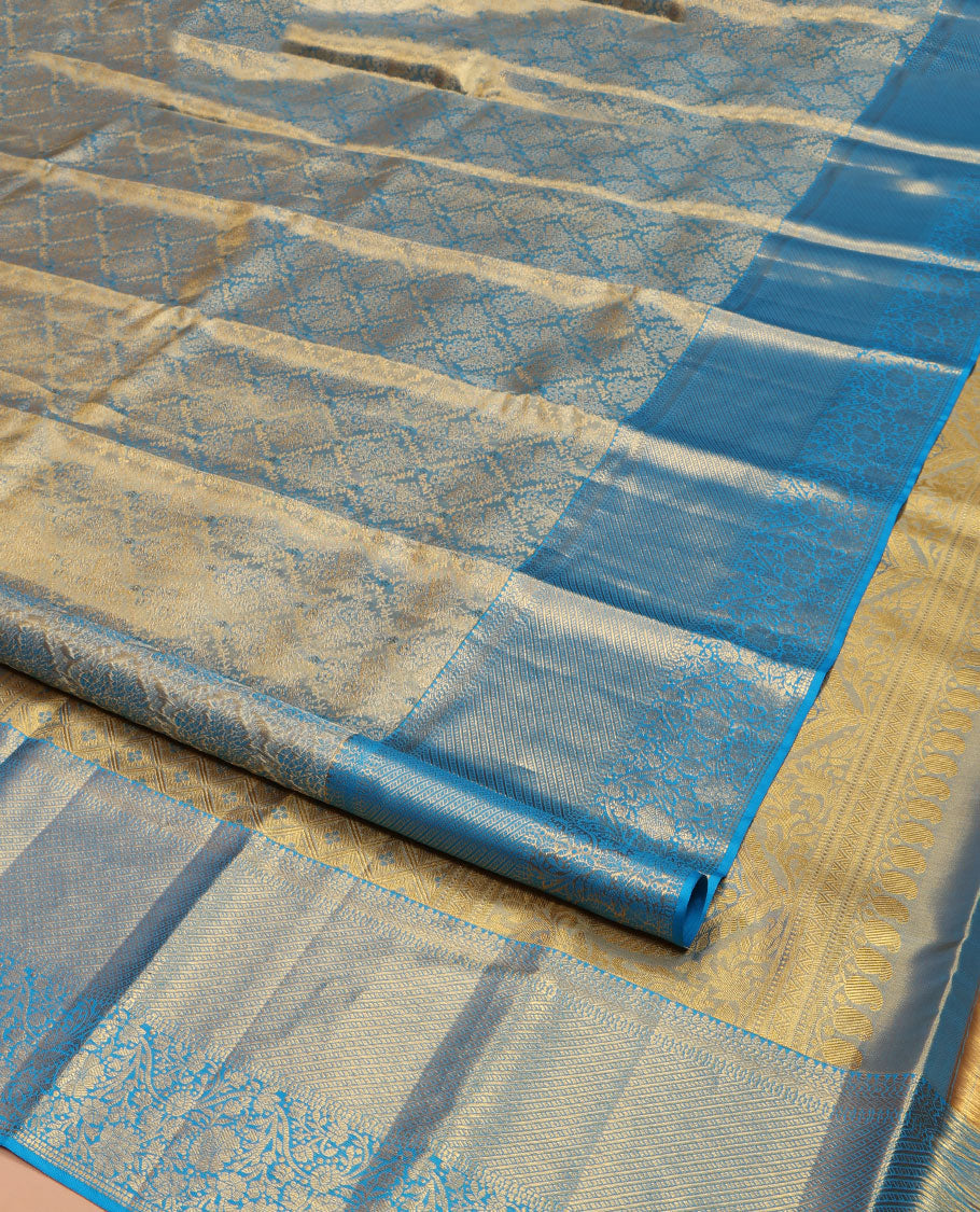Blue Kanchipuram Silk Saree, Mesmerized with Zari Jacquard Design All Over Its Body, Highlighted by a Zari Border of Thilakam, Muthu, Kathir, Diamond, and Floral Designs, and Pallu of Jaal Designs, and Paired with a Matching Blouse